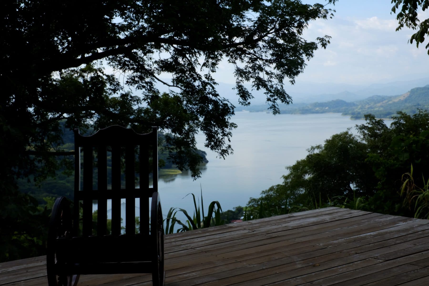 Rocking chair on a wooden terrace overlooking Lake Suchitlán