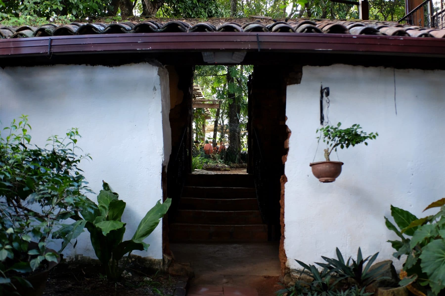 Colonial courtyard entrance with whitewashed walls and clay tile roof