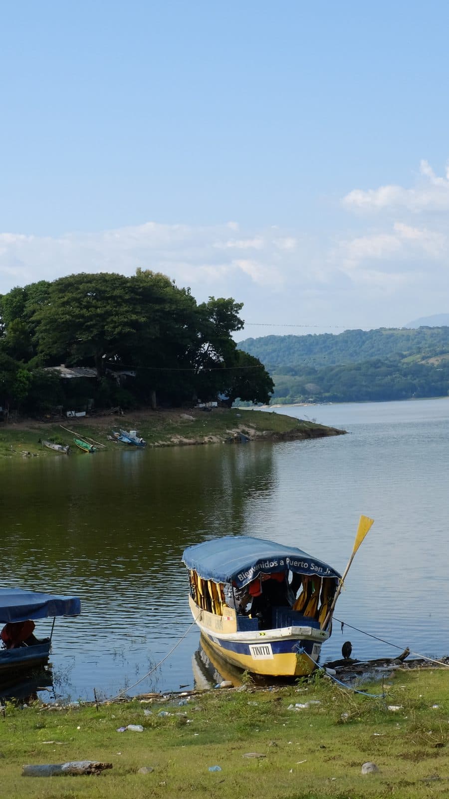 A tour boat moored on the shore of Lake Suchitlán