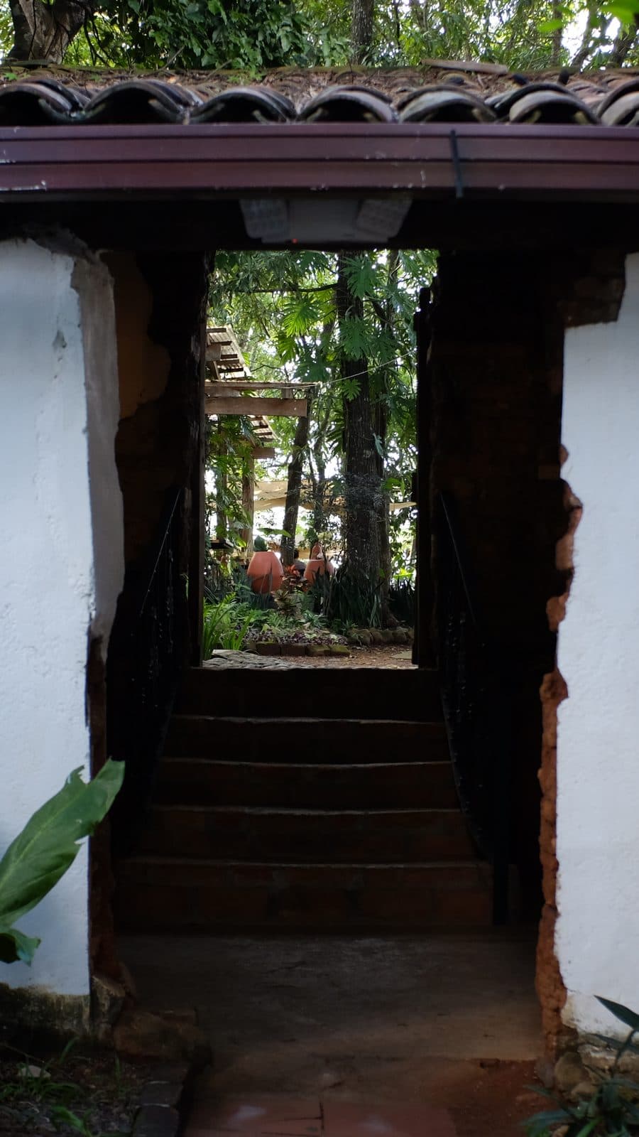 Whitewashed colonial doorway under a clay tile roof