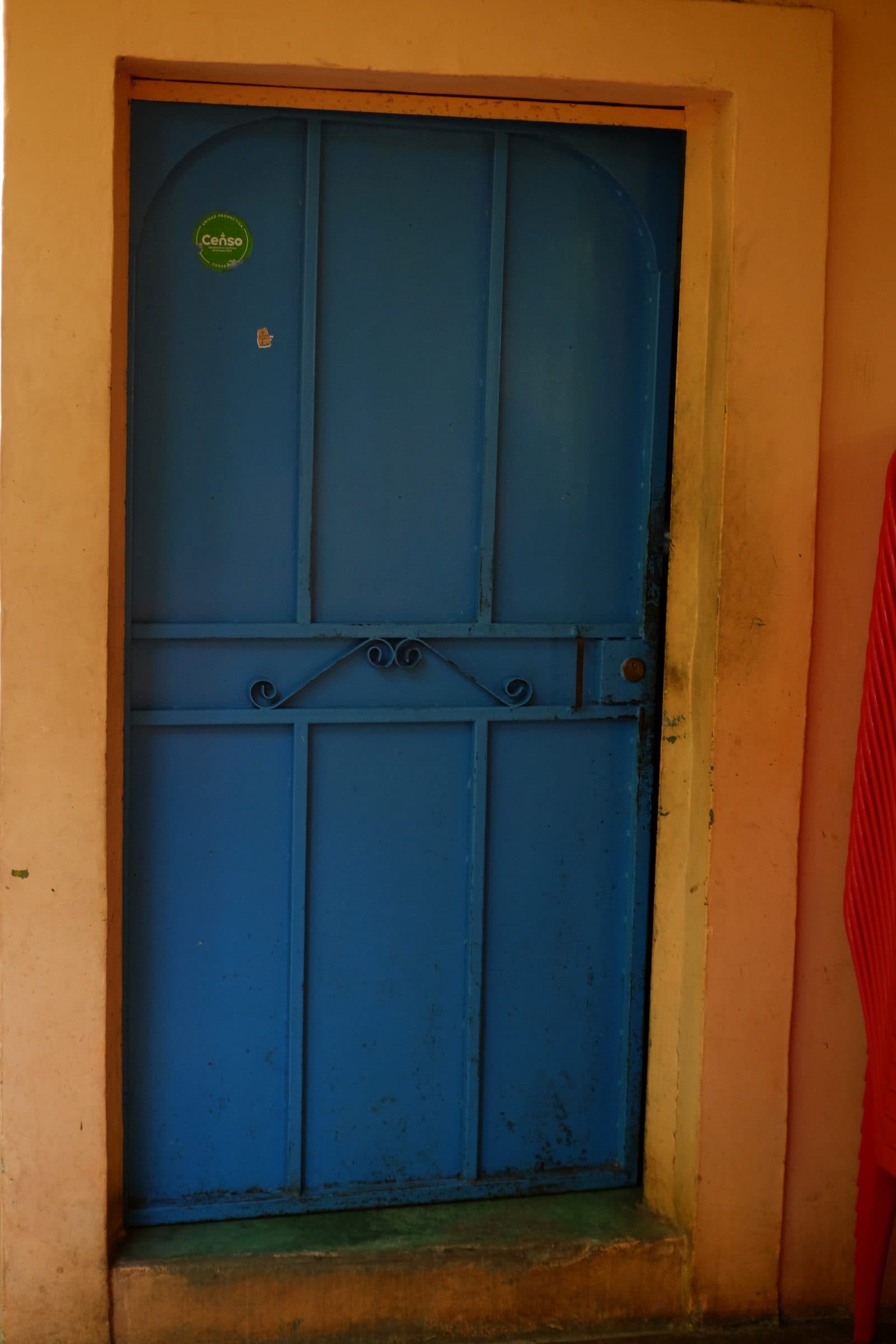 Blue colonial door on an ochre façade